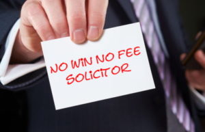 an image of a man in a suit holding up a sign that says "no win no fee solicitor"