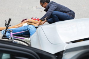 Cyclist hit by a car pulling out of a driveway