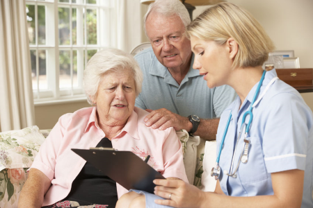 a nurse reviewing a medication list with a care home resident