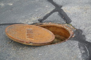 Open manhole cover on a road