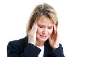 Stressed woman holding her head in pain