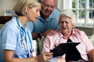 A nurse, patient and family member of the patient looking at test results