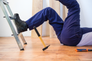 a man falling off a ladder and landing on his back