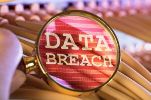 a magnifying glass showing the text "data breach"