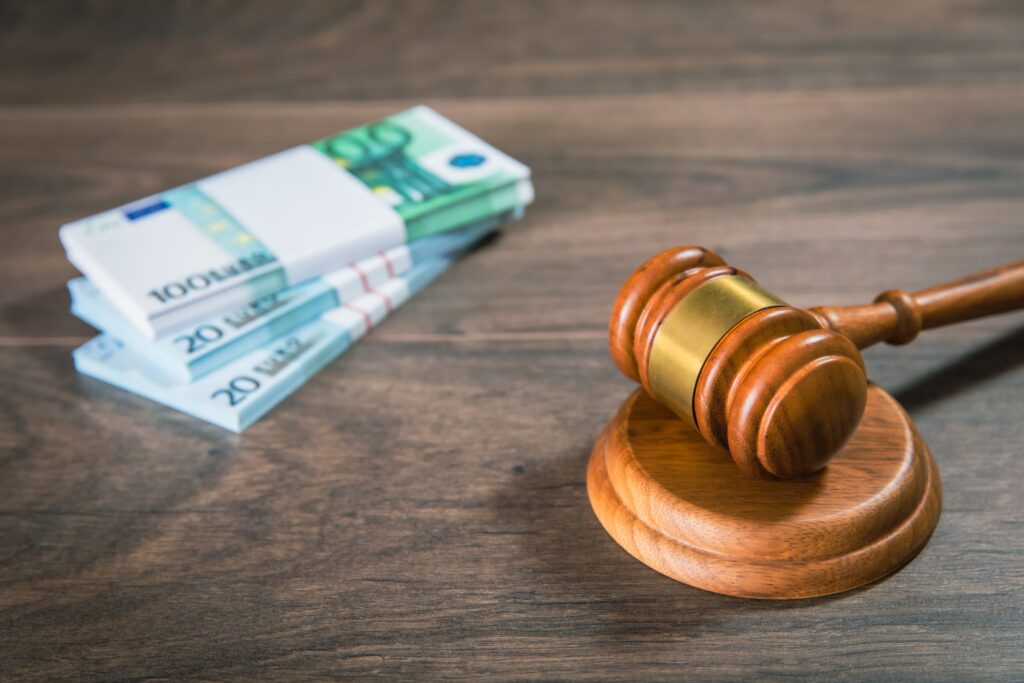 a picture of a judge's hammer and some money on a table