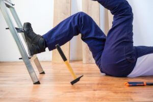 A close up shot of a man falling from a ladder.