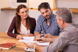 A couple with a solicitor discussing child personal injury claims. 