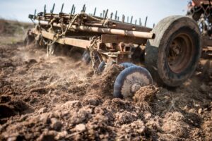 Farming equipment in dirt. 