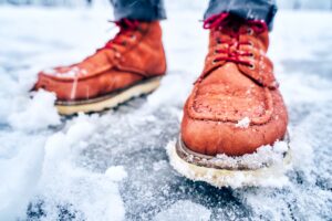 A close up shot of someone standing on snow and ice.