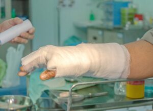 A heavily burned arm wrapped in thick bandages.