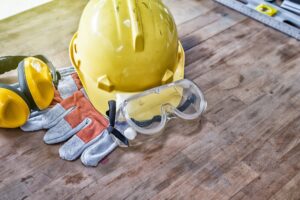 Standard construction safety equipment on wooden table.