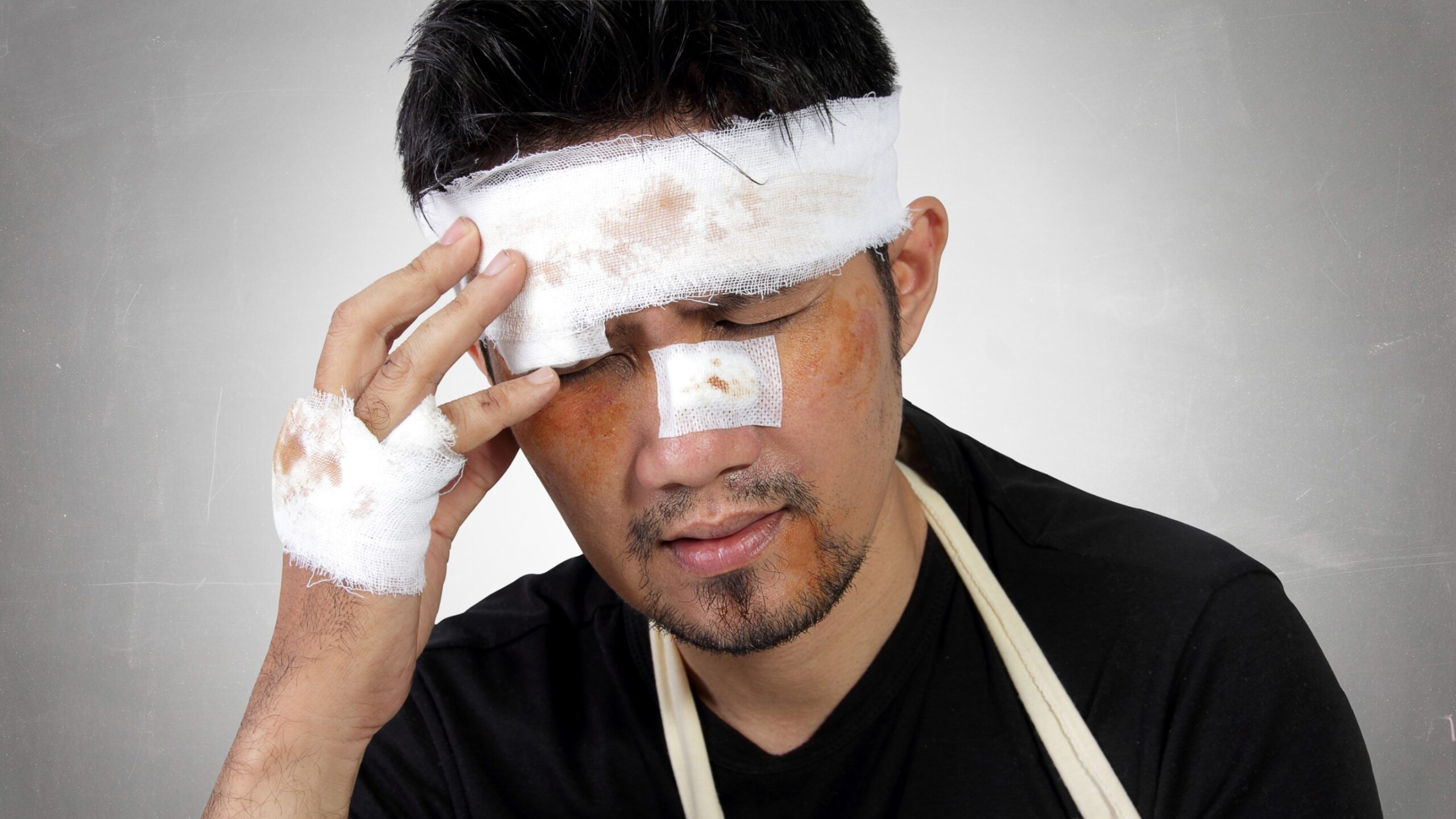Man With Bandaged Wounds On His Face.