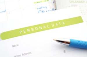 a document titled personal data with the words name and address and a pen close by. 
