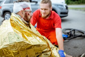 A cyclist with a head injury receiving medical care.