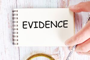 A notebook with the word 'evidence' over the top.