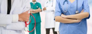 Hospital staff standing with their arms crossed. 