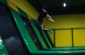 Man jumping around in a trampoline park