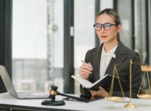 An accident at work lawyer sitting at a desk holding a notebook and pen