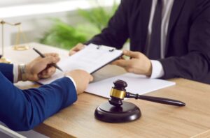 A solicitor discussing NHS medical negligence payouts with a claimant.