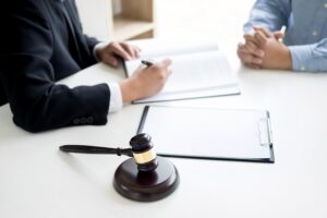A solicitor explaining how to sue a hospital for negligence to a client.