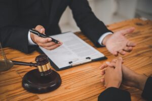 A medical negligence solicitor explaining stroke misdiagnosis claims while sitting at a table.