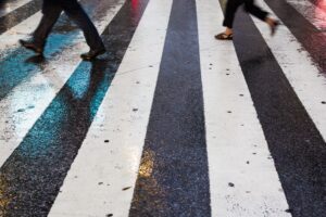 People walking across a zebra crossing.