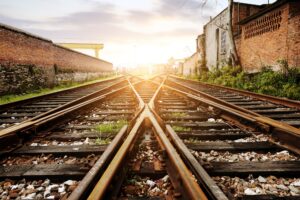 A close-up image of train tracks at sunrise.