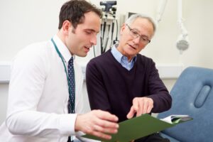 A consultant shows test results to a patient.