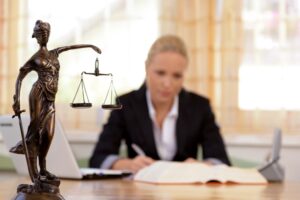 A dog bite claim solicitor sitting at a desk and writing in a book.