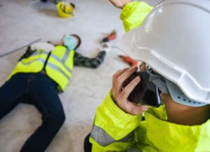 A supervisor calling emergency services after seeing an employee injured at work