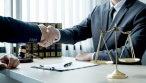 A solicitor and client shake hands. 