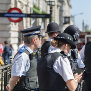 A group of police stand at the entrance to a station.
