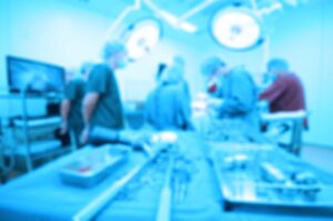 A blurred image of surgeons performing an operation.