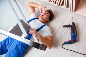A self-employed contactor on the floor following a ladder accident. 