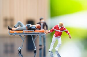 Plastic figure on a stretcher representing work injuries. 