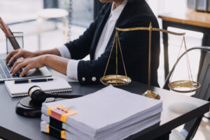 A No Win No Fee lawyer reviews a pile of dental negligence claims on their desk.