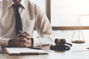 A No Win No Fee solicitor at a table with paperwork about permanent scar compensation. 