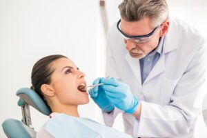 DENTIST PERFORMING A PROCEDURE ON A PATIENT