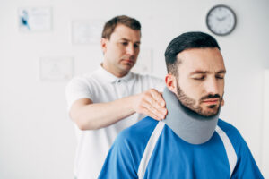 A man with a neck injury with a medical professional.