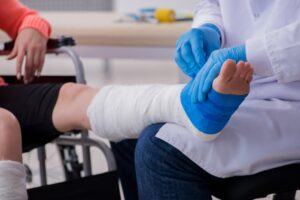 PERSON IN A WHEELHAIR AND A LEG CAST AFTER FALLING FROM SCAFFOLDING