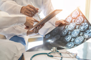MEDICAL PROFESSIONALS LOOKING AT MRI SCANS 