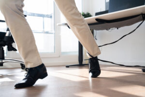 A man trips over a wire that had been left dangling in an office.