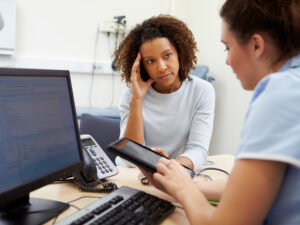 A woman talks to a nurse about the early stages of cancer.