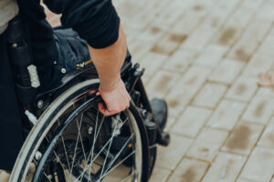 A man in a wheelchair going to learn about paralysis injury claims.