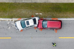 A birds-eye view of a rear-end collision between a red and silver car.